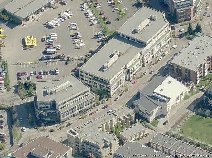 Contemporary commercial buildings with a sleek design and ample parking space in Jutland