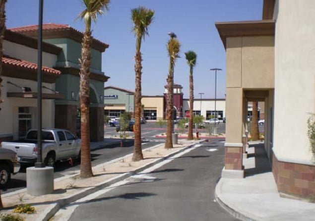 a street with palm trees and a truck